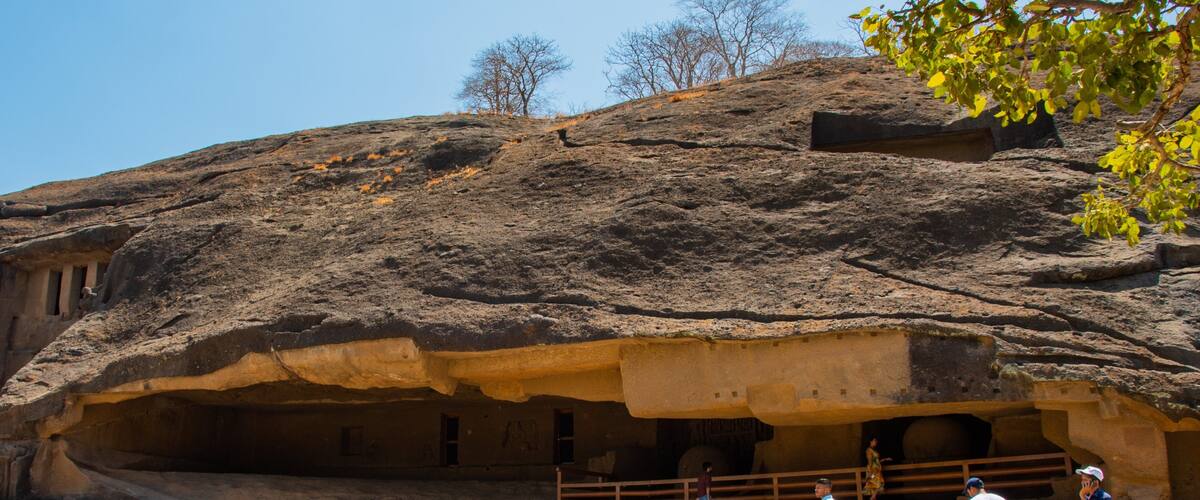 Kanheri Caves featuring caves as well as a small group of people