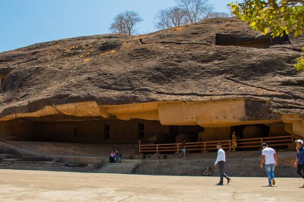 Kanheri Caves featuring caves as well as a small group of people