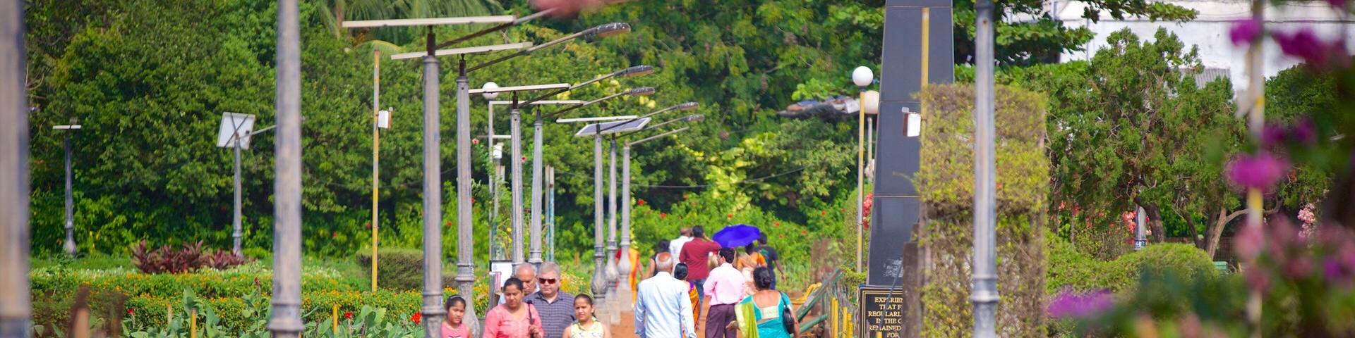 A pathway lined with benches and people walking.