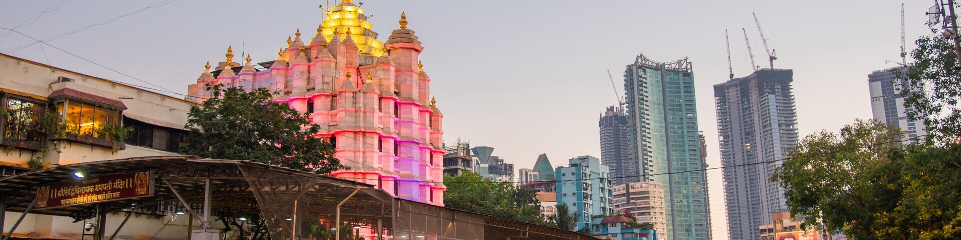 Siddhi Vinayak Temple which includes a city, heritage architecture and a sunset