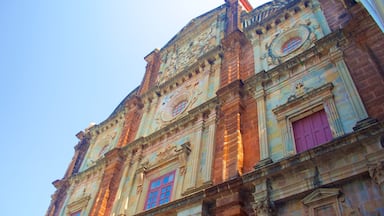 A historic building with ornate architectural details, including a clock and decorative windows.