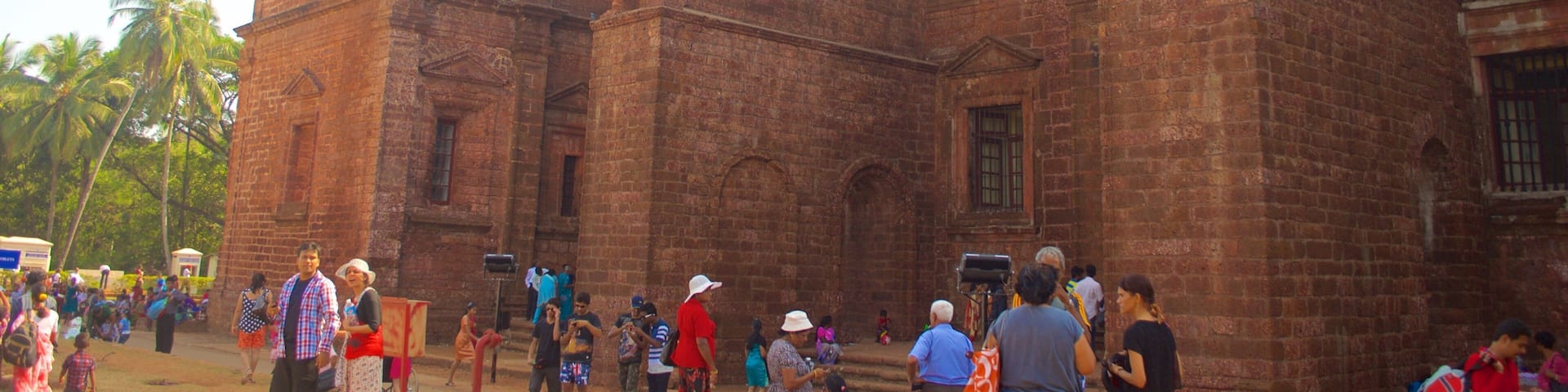 A large brick building with multiple windows and a balcony.