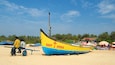 Calangute Beach showing a sandy beach and general coastal views as well as a small group of people