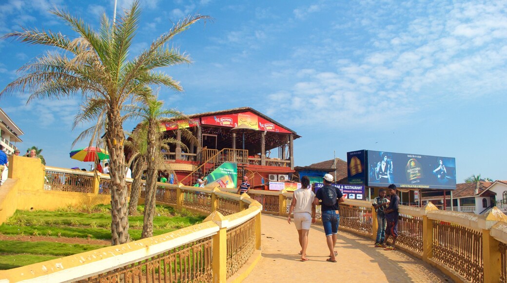 Spiaggia di Calangute che include località costiera e bar sulla spiaggia cosi come un piccolo gruppo di persone