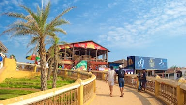 Calangute Beach showing a coastal town and a beach bar as well as a small group of people