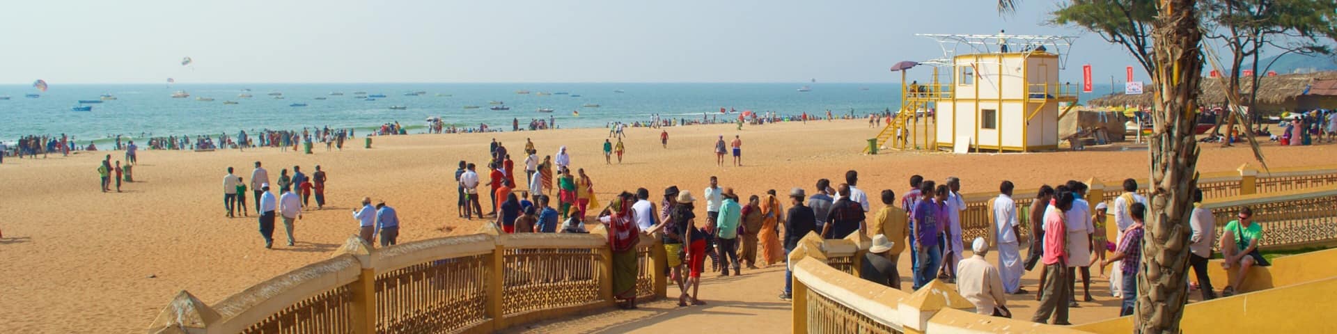 Calangute Beach which includes a sandy beach and general coastal views as well as a large group of people