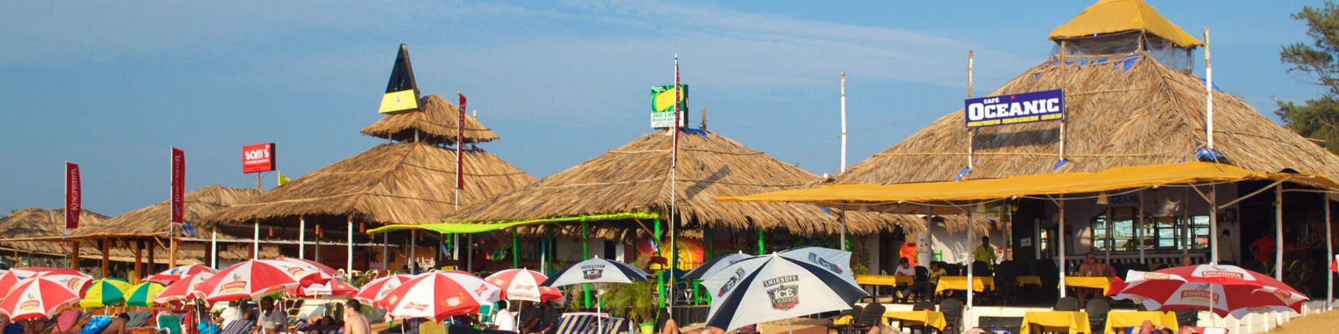 Baga Beach showing a beach bar and a sandy beach