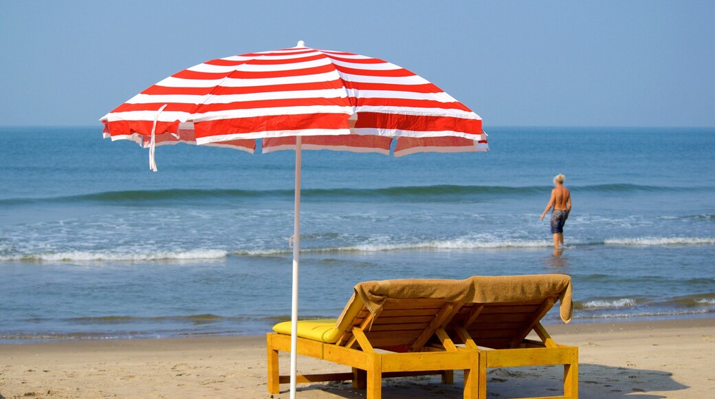 Vagator Beach featuring general coastal views and a beach as well as an individual male