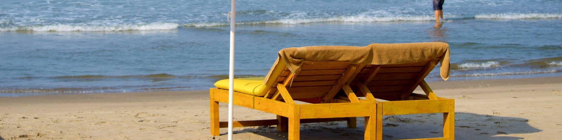 Vagator Beach featuring general coastal views and a beach as well as an individual male