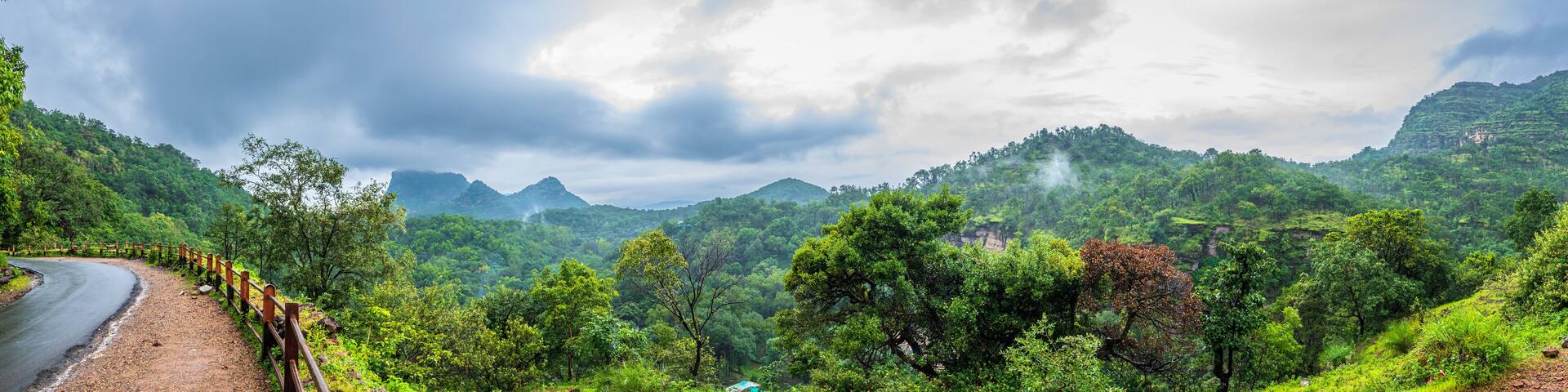 Panoramic view of Pachmarhi valley having clouds and mist shrouded hills rolling on each other from Chaudeshwar Mahadev Temple road in Pachmarchi, Madhya Pradesh, India.