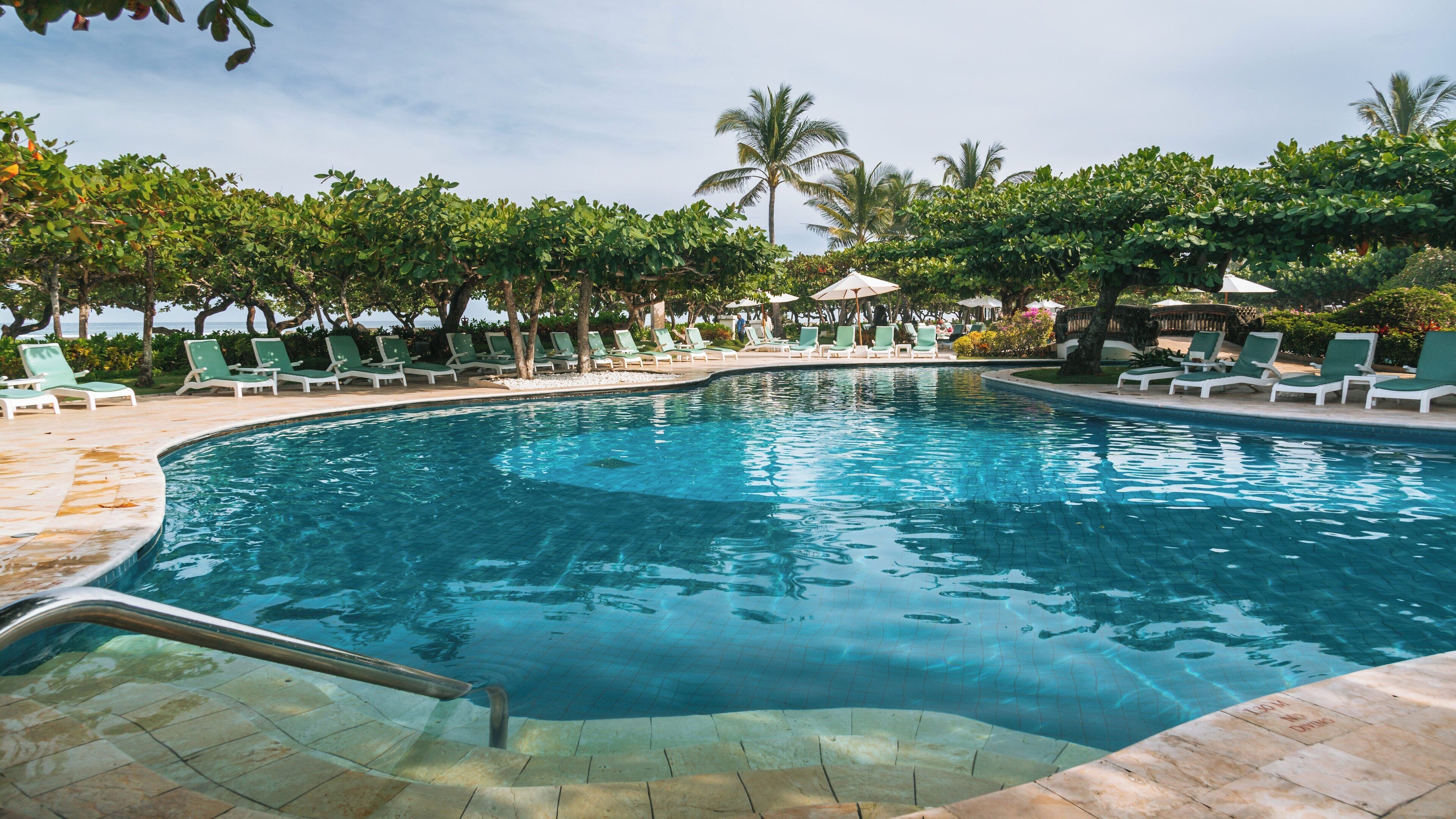 Tropical retreat at Nusa Dua Beach in Seminyak, Bali offers serene relaxation by the poolside