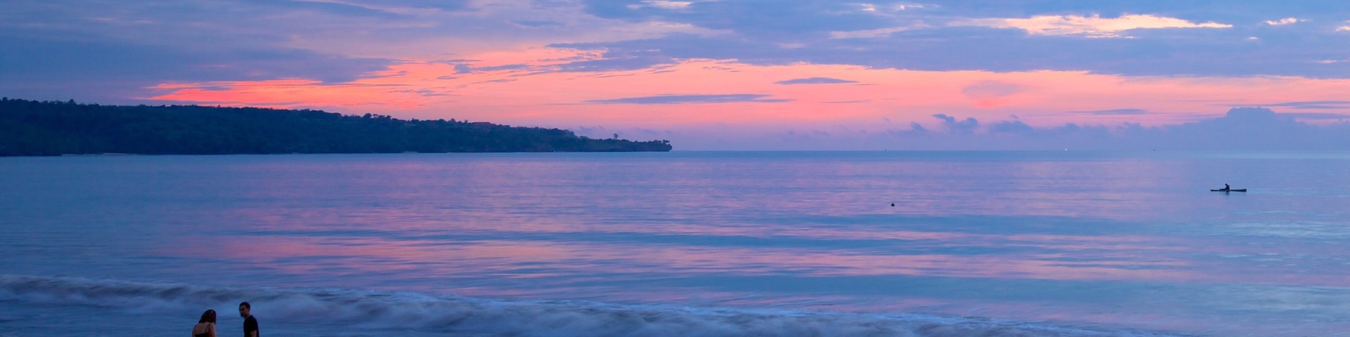 Jimbaran Beach featuring a sunset and a sandy beach