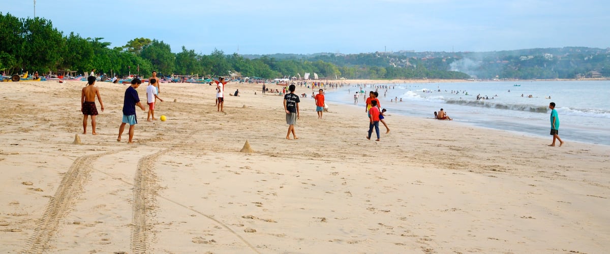 Jimbaran Beach featuring a beach as well as a large group of people