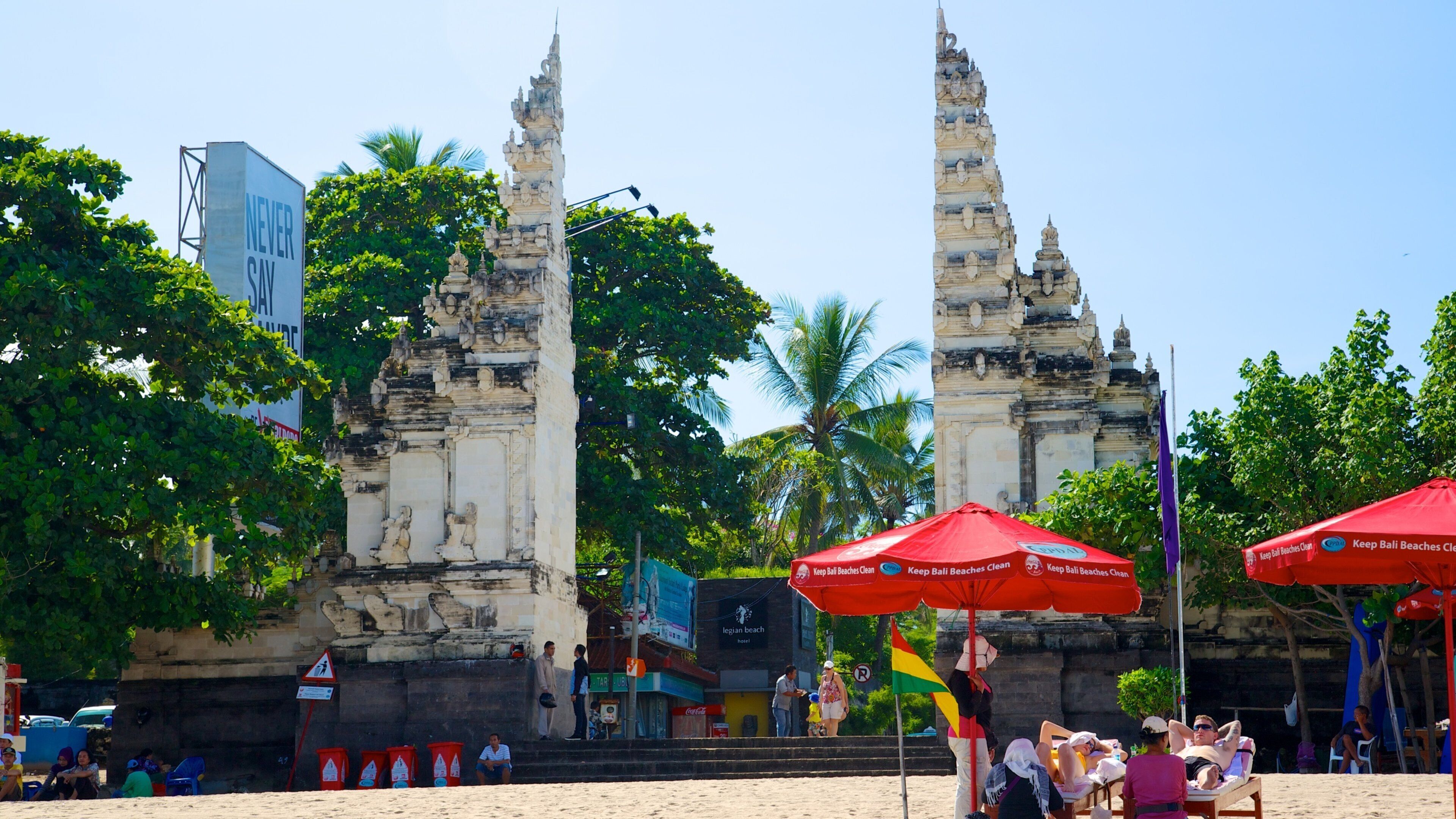 Kuta Beach which includes tropical scenes, street scenes and a temple or place of worship