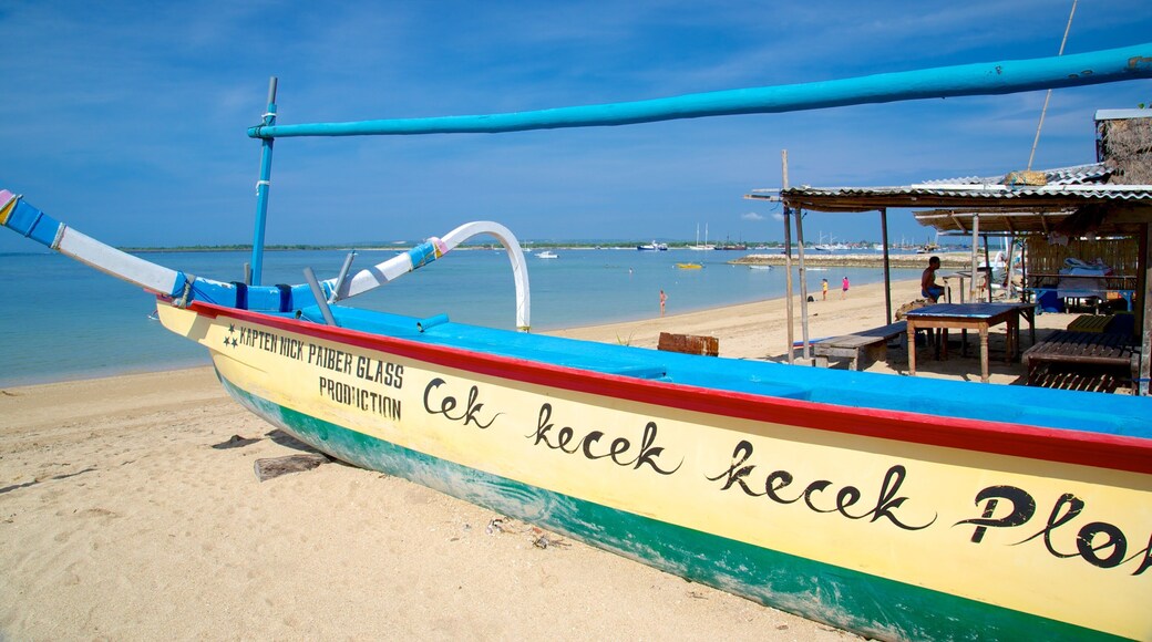 Playa de Sanur que incluye escenas tropicales, embarcaciones y una playa