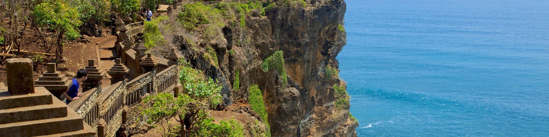 Uluwat Temple featuring landscape views, a temple or place of worship and rugged coastline