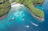 Aerial view of traditional Balinese boats (Jukung) and divers in Blue Lagoon. Padangbai, Bali, Indonesia.
