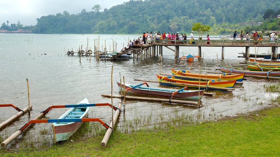 A lakeside scene with colorful boats docked at a pier.