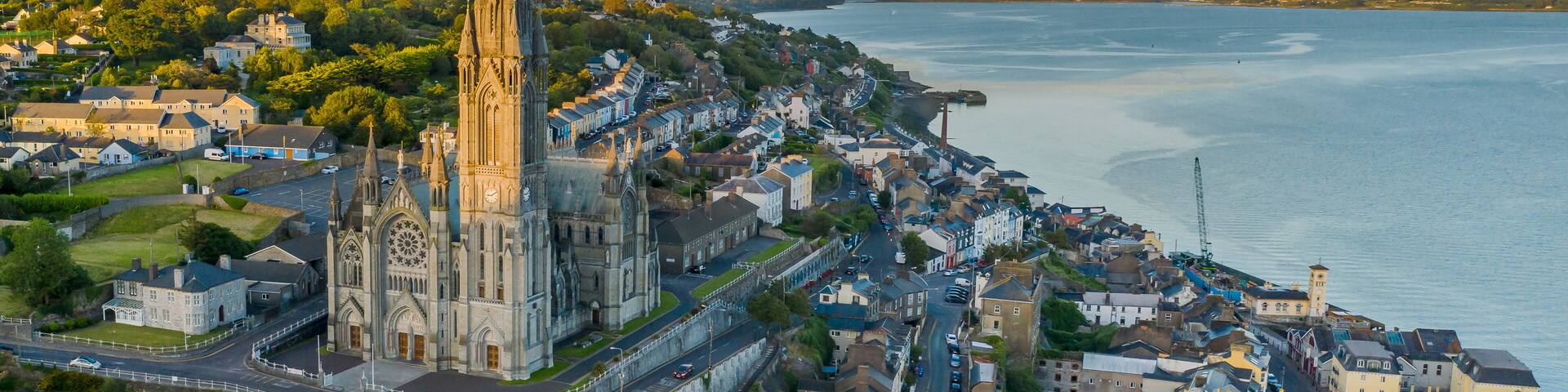 A coastal town with a prominent church spire, a harbor, and a mix of residential and commercial buildings.