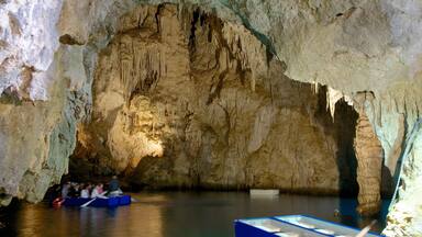 Emerald Grotto featuring boating, caving and caves