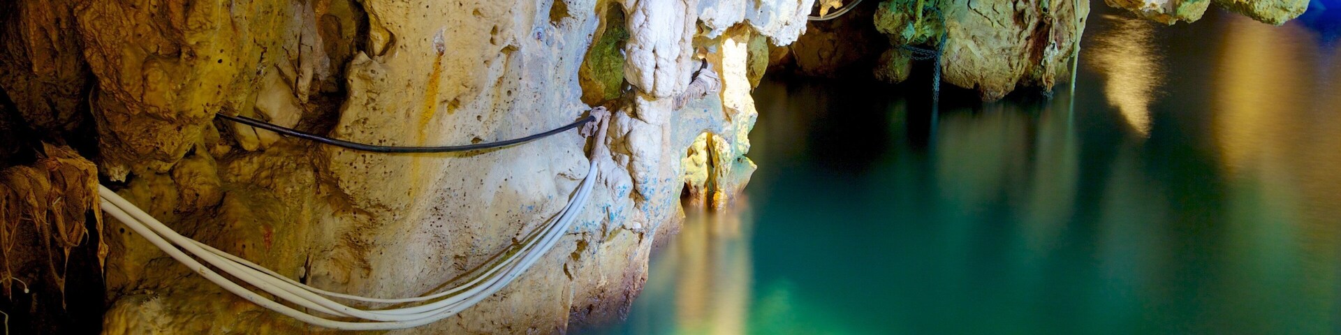 Emerald Grotto featuring rugged coastline and caves