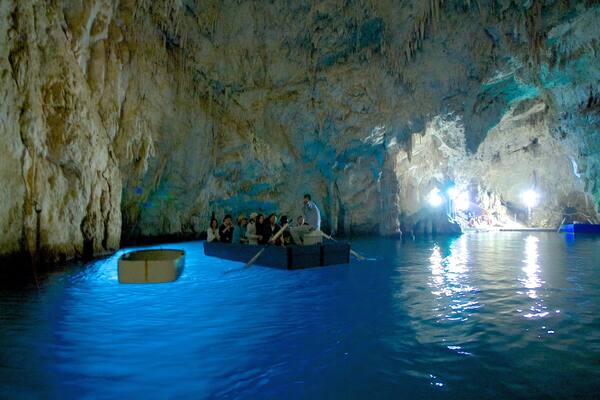 Emerald Grotto featuring caves, boating and interior views