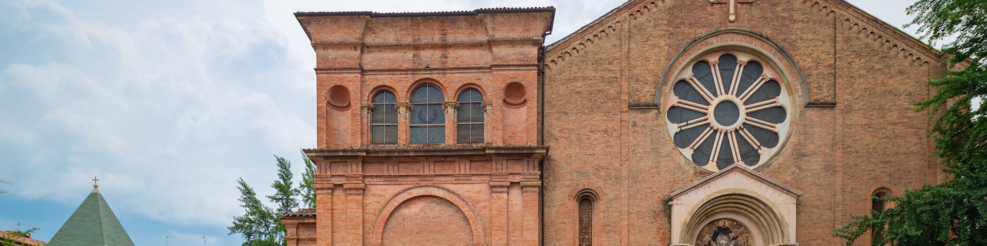 A historic church with a large rose window and a bell tower.