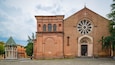 A historic church with a large rose window and a bell tower.