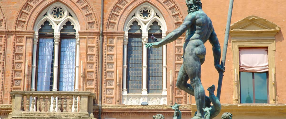 A bronze statue of a man holding a spear, with a bird perched on his hand, in front of a building with arched windows and decorative stonework.