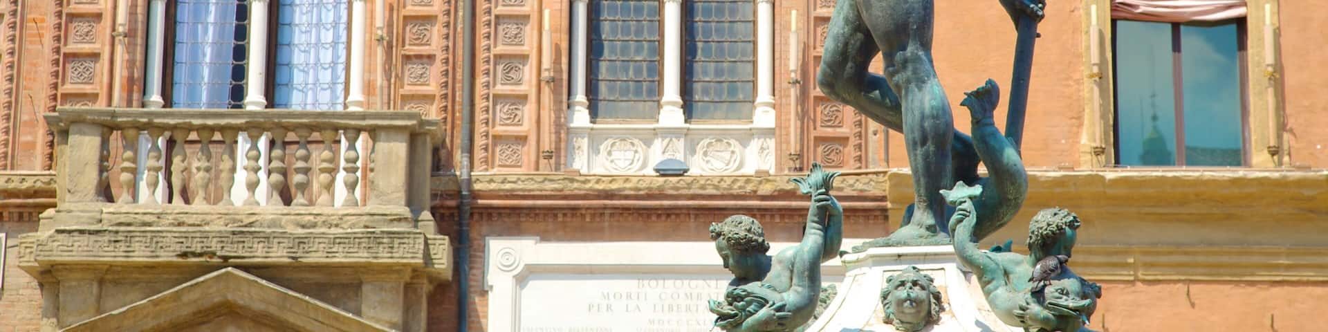 A bronze statue of a man holding a spear, with a bird perched on his hand, in front of a building with arched windows and decorative stonework.