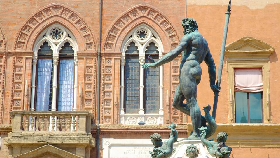 A bronze statue of a man holding a spear, with a bird perched on his hand, in front of a building with arched windows and decorative stonework.