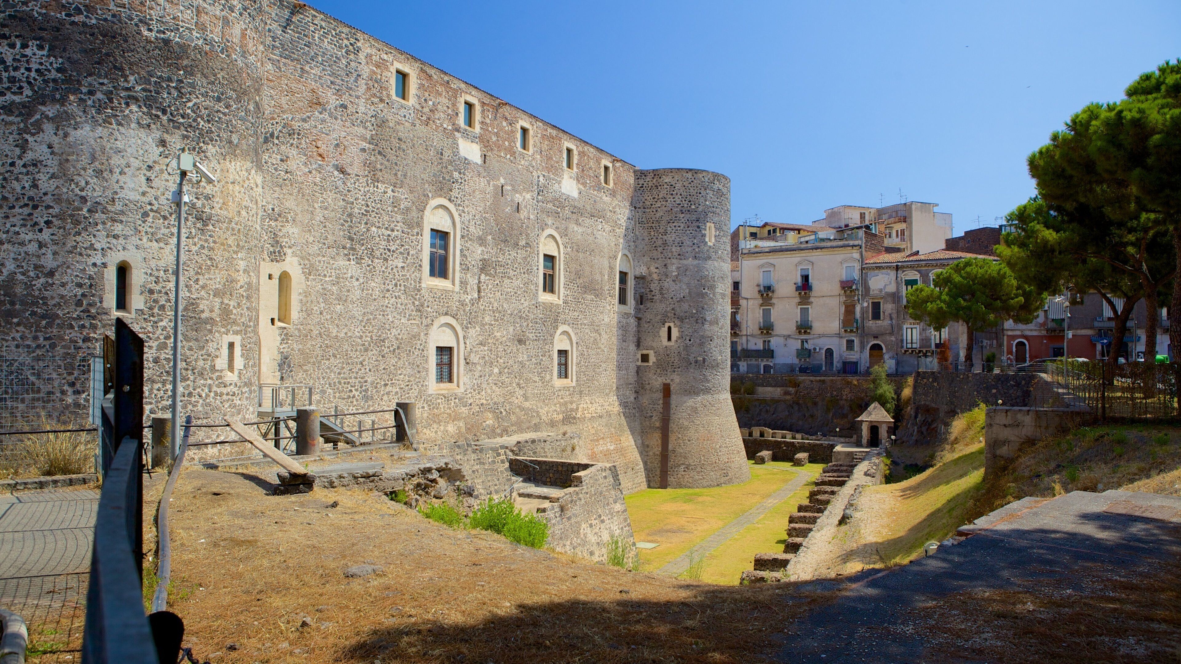A historic stone fortress with arched windows and a central tower.