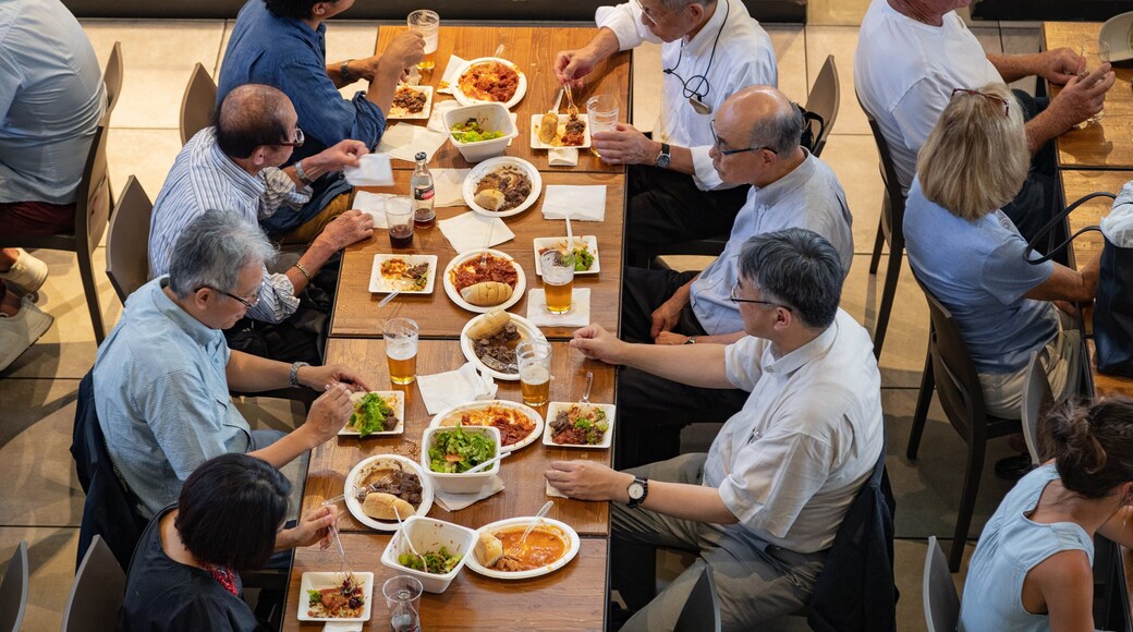 Central Market showing dining out as well as a small group of people
