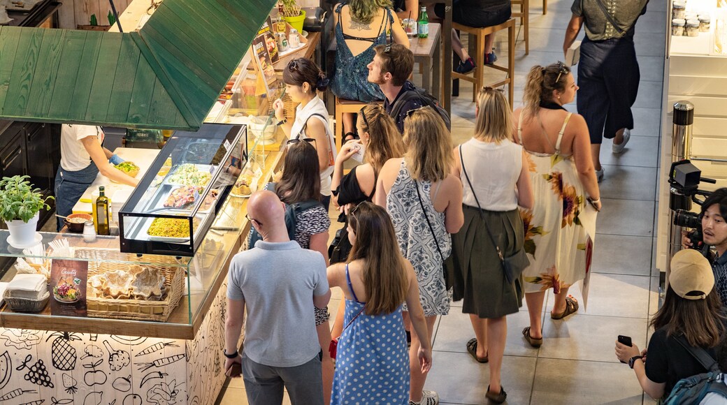 Central Market showing cafe scenes and interior views as well as a small group of people