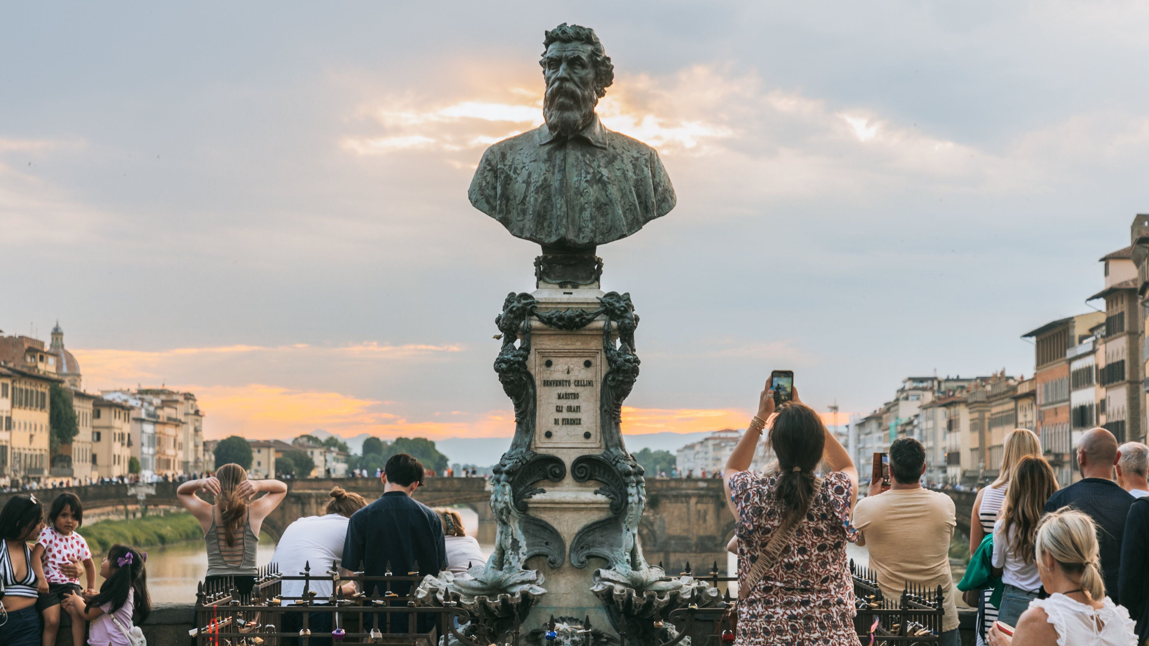 Ponte Vecchio featuring views, a sunset and a statue or sculpture