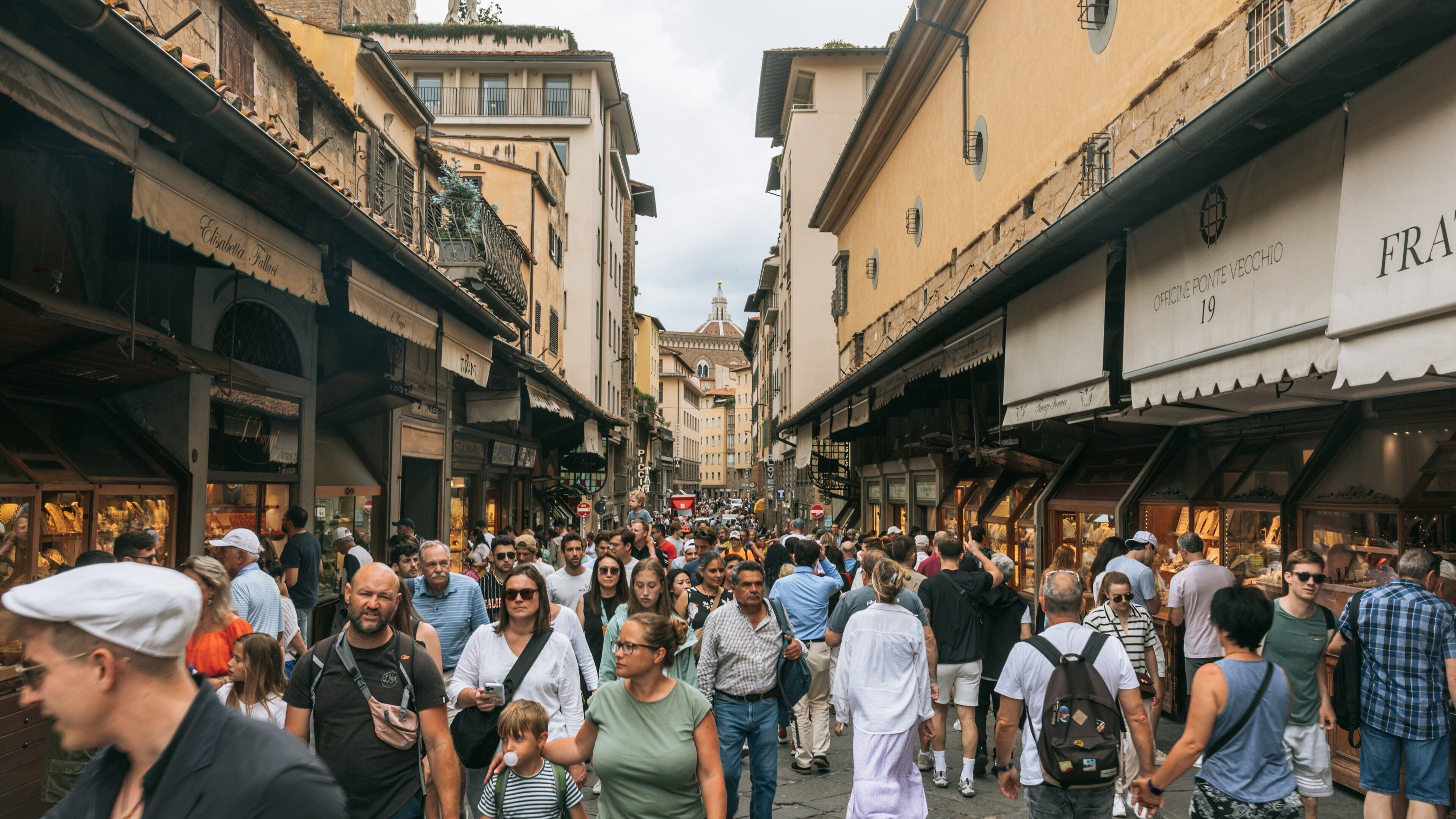 Ponte Vecchio which includes a city and street scenes as well as a large group of people