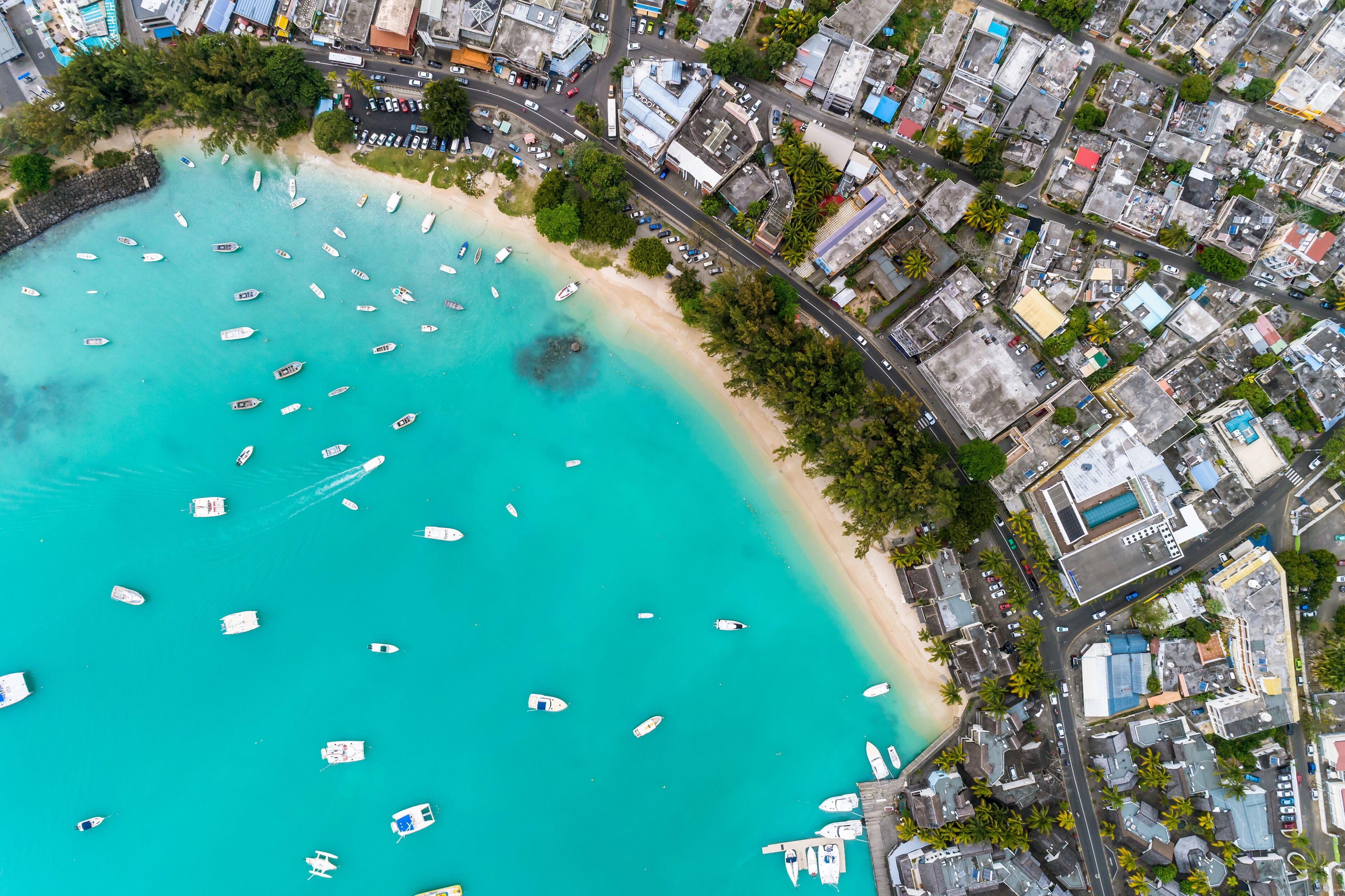 Aerial view of the beach with palm trees and sea. Grand Baie Beach, Mauritius.