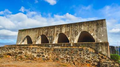 A large stone structure with multiple arched openings and a stone ramp leading up to it.