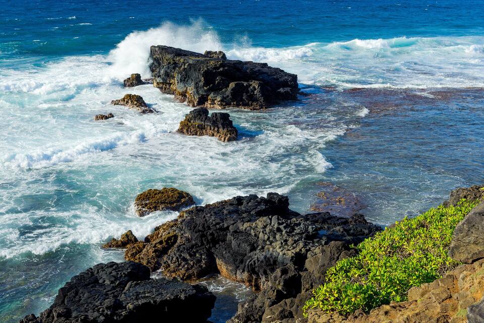 A rocky coastline with waves crashing against the rocks.
