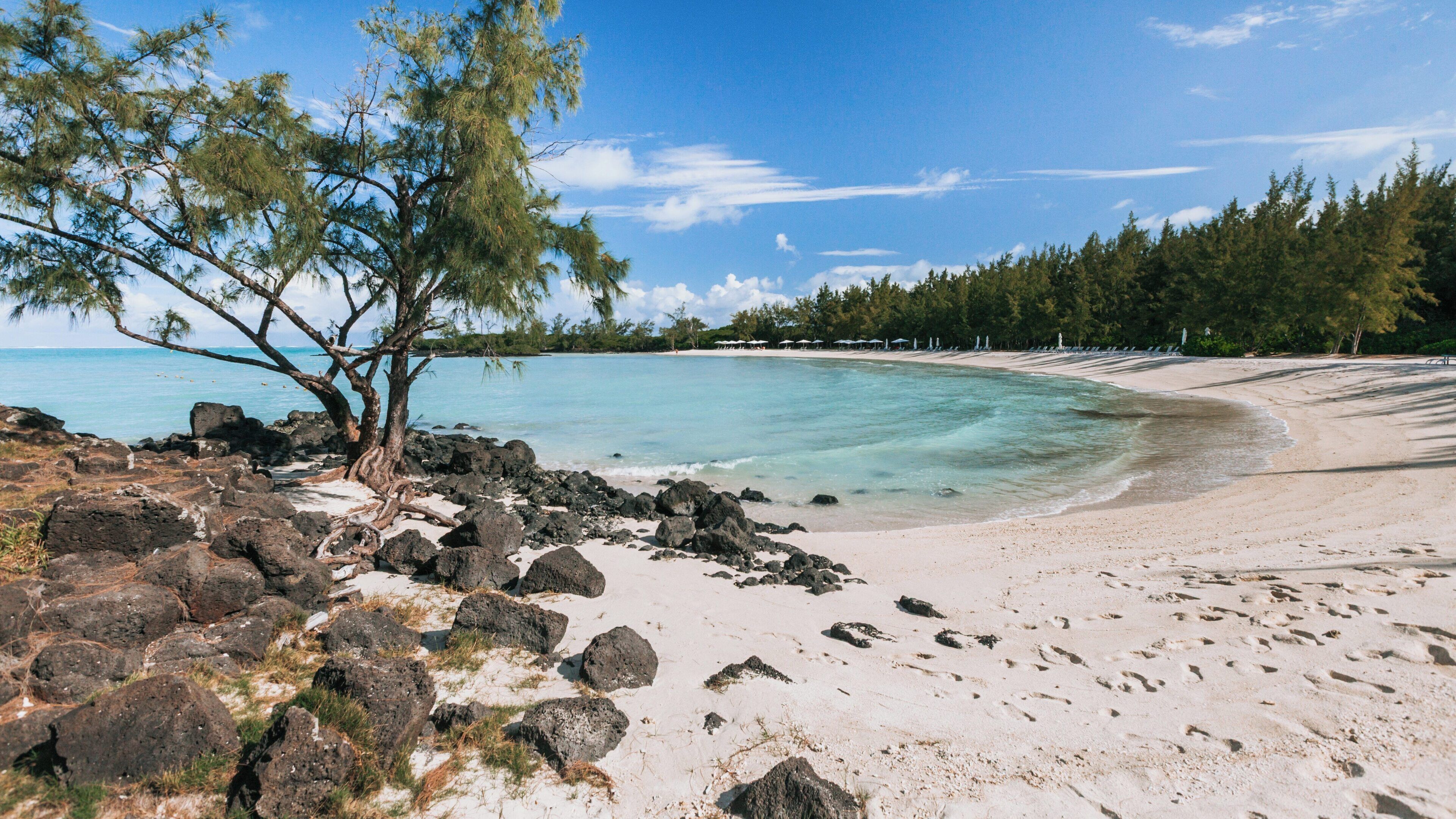 Serene Ile aux Cerfs Beach in Belle Mare, Flacq District, Mauritius on a sunny day with gentle waves