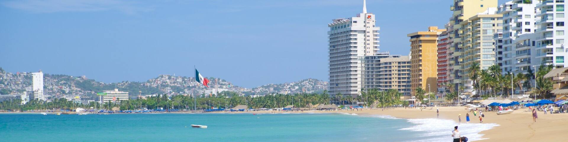 Condesa Beach showing a coastal town and a sandy beach