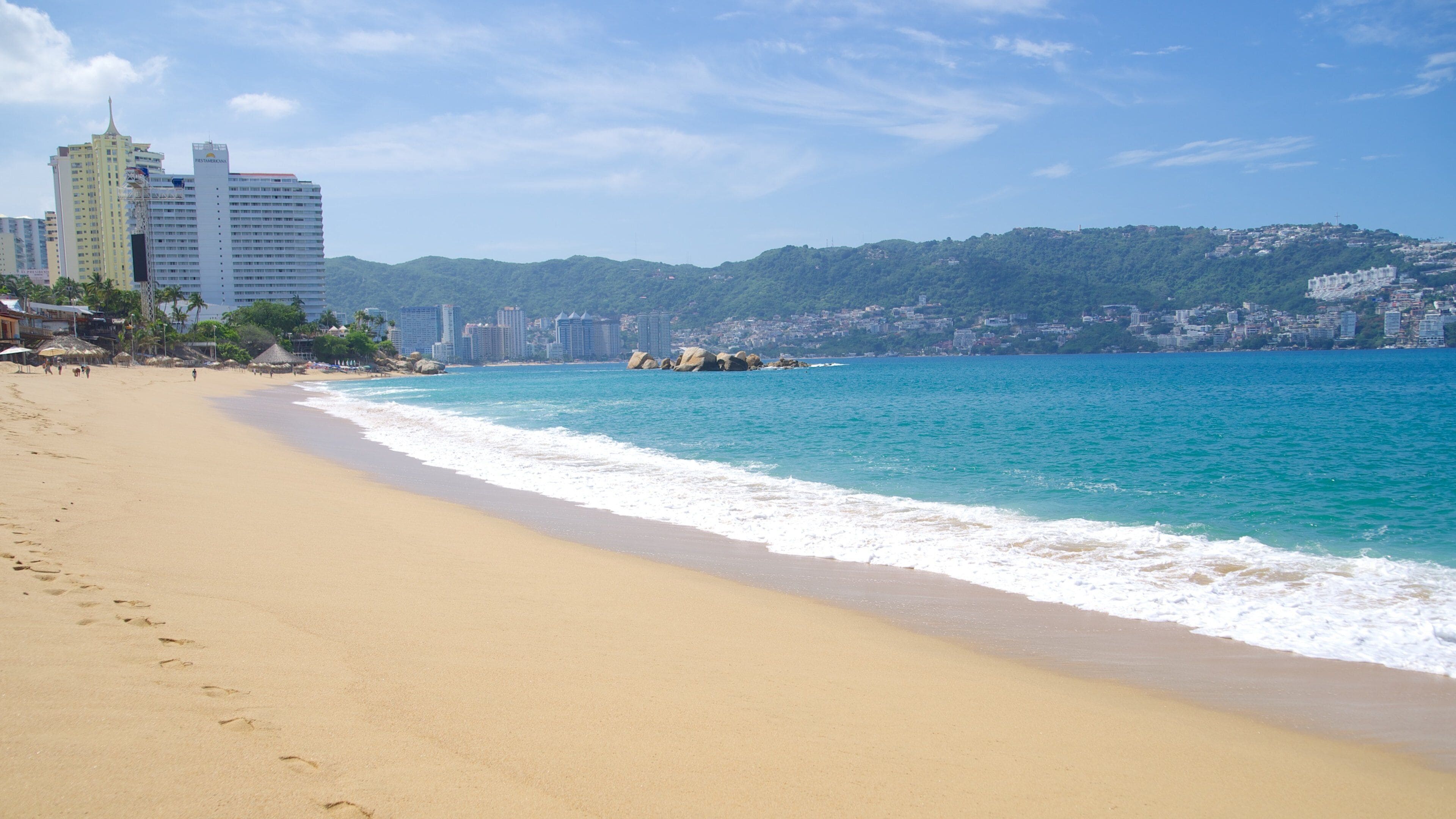 Condesa Beach showing a beach and a coastal town
