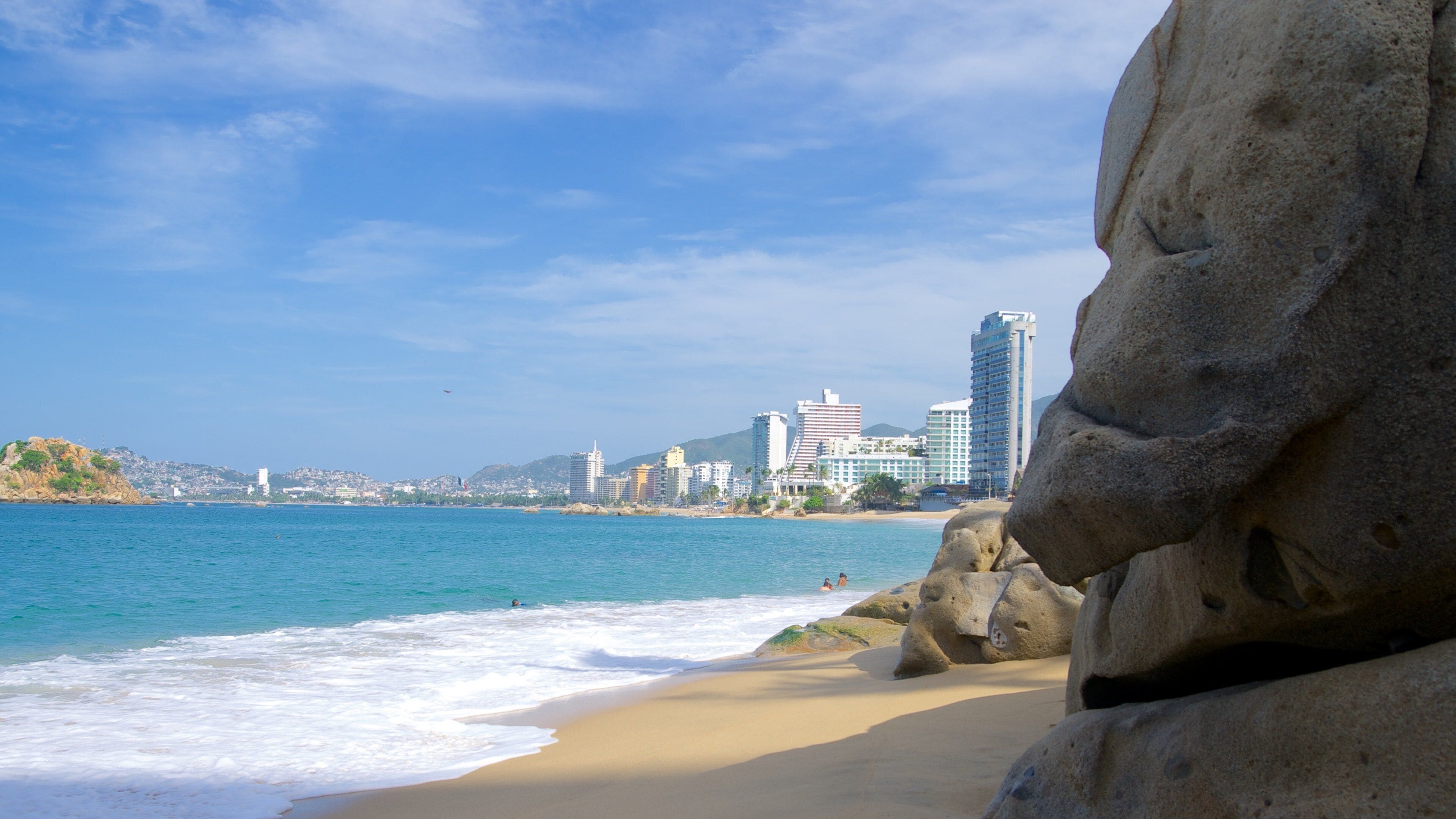 Condesa Beach which includes a coastal town and a beach