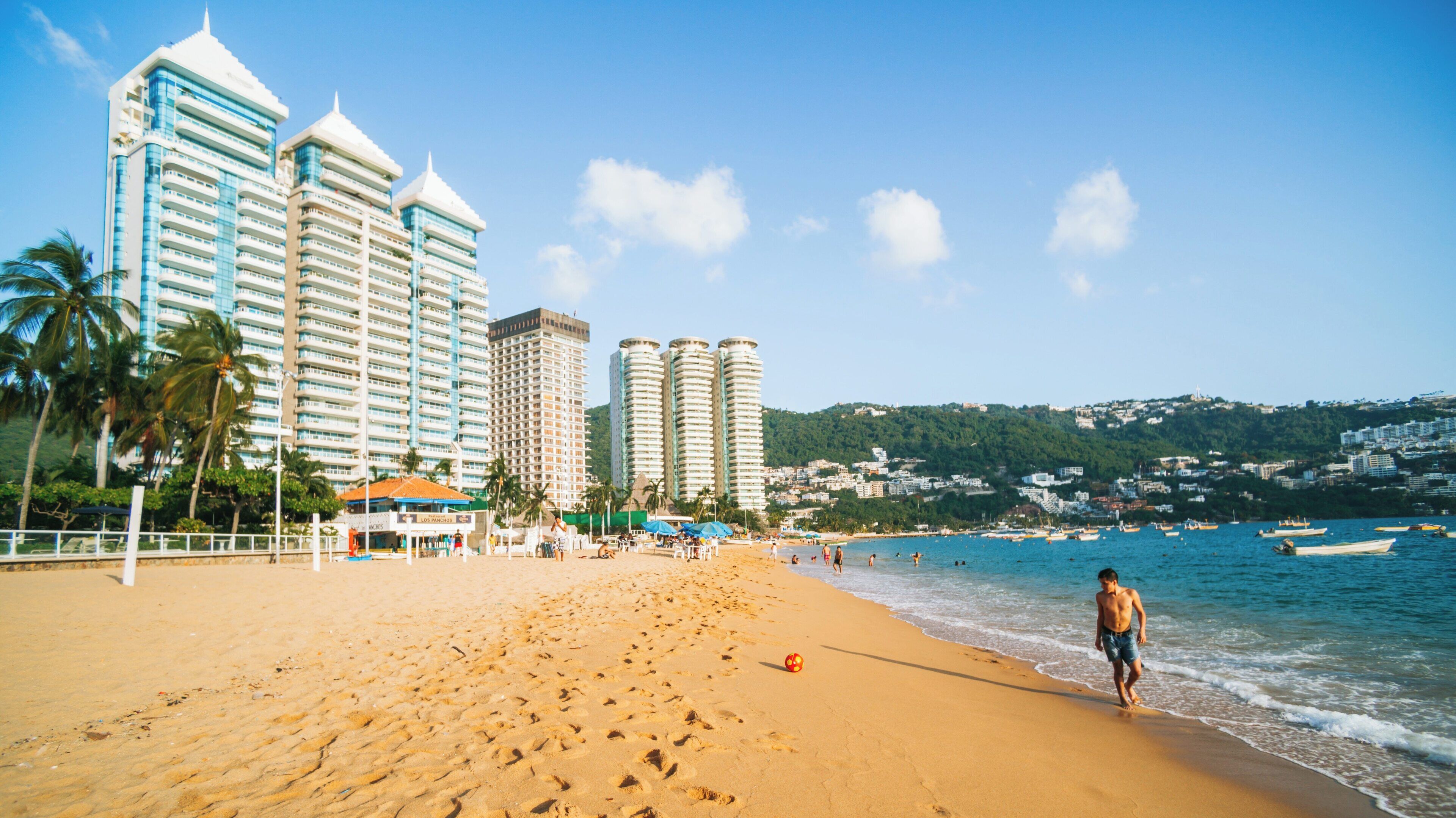 Icacos Beach in Costera Acapulco offers sun, sand, and leisure time with stunning views of city resorts and vibrant ocean