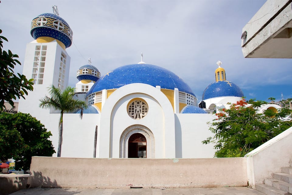 Igreja com cúpulas azuis e paredes brancas.