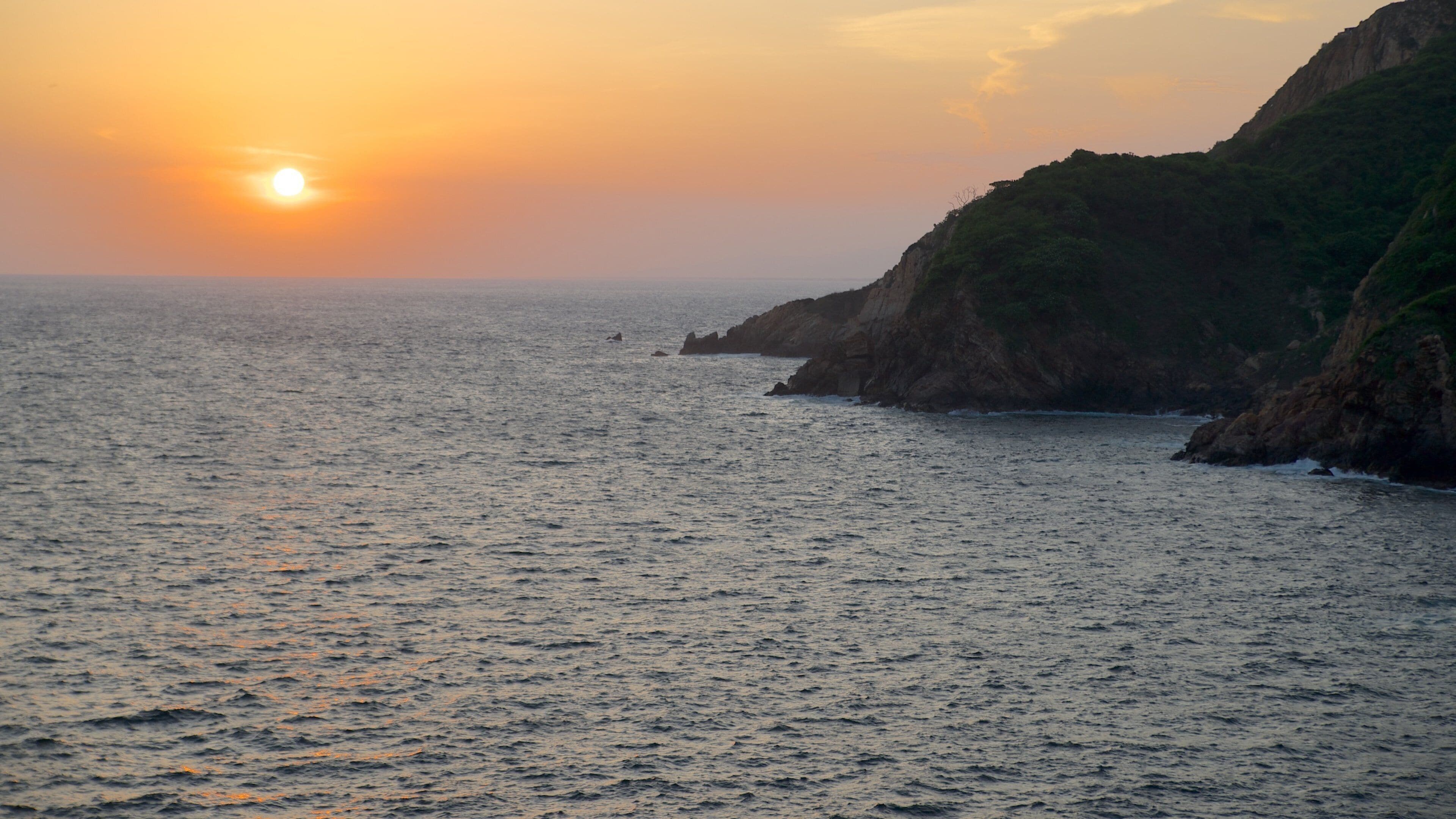 Sinfonia featuring a sunset, rocky coastline and landscape views