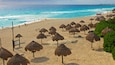 Playa Delfines which includes tropical scenes, general coastal views and a beach