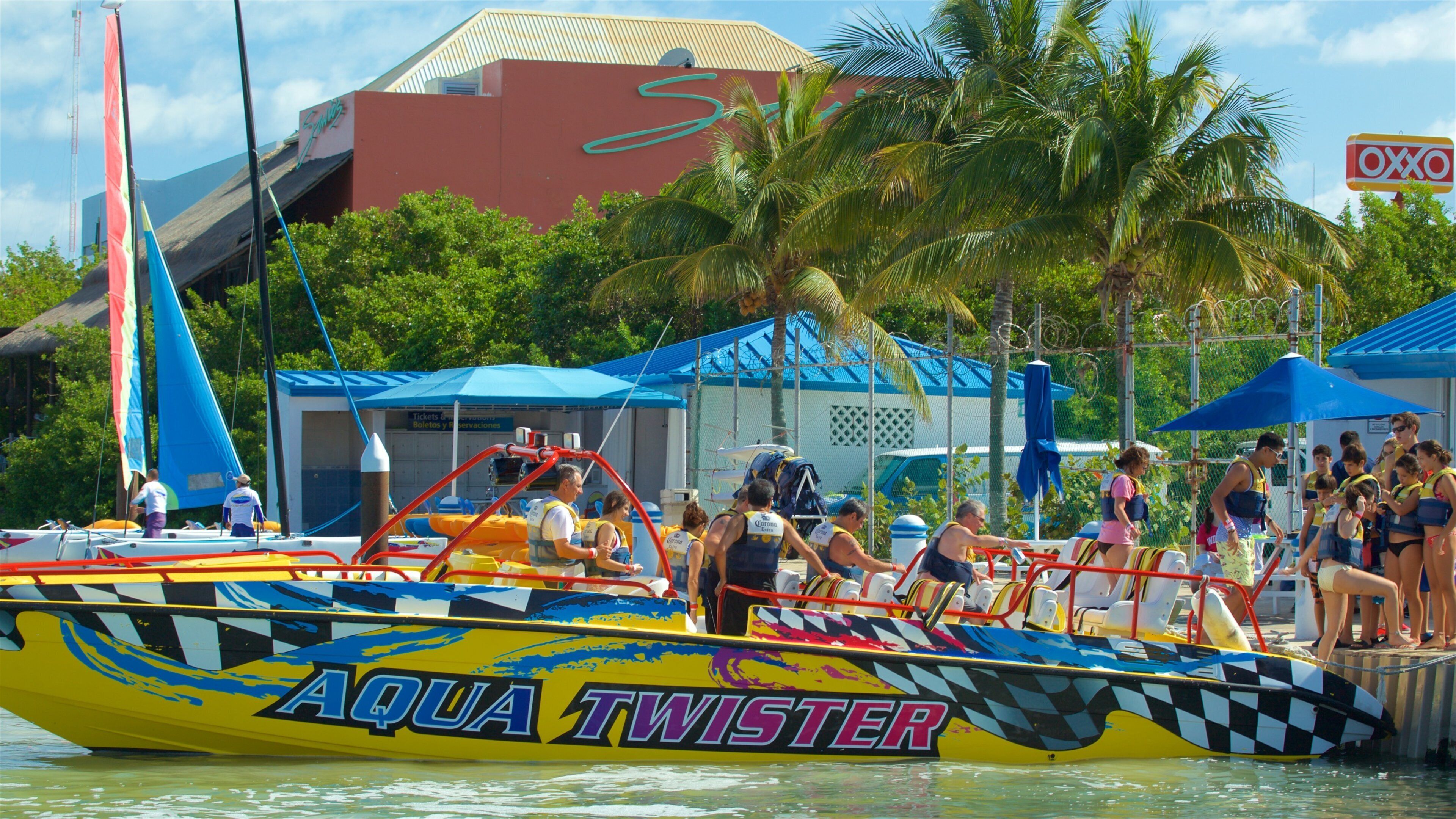 Aquaworld showing signage and boating as well as a small group of people