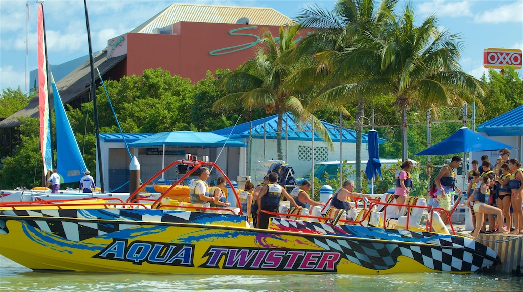 Aquaworld showing signage and boating as well as a small group of people