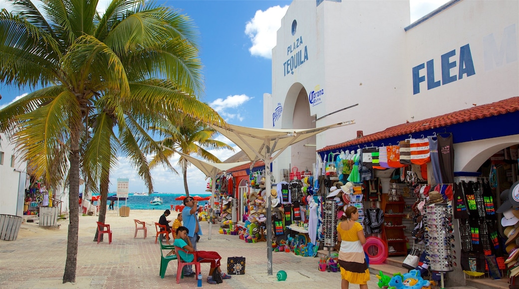 Tortuga Beach showing signage, a coastal town and markets